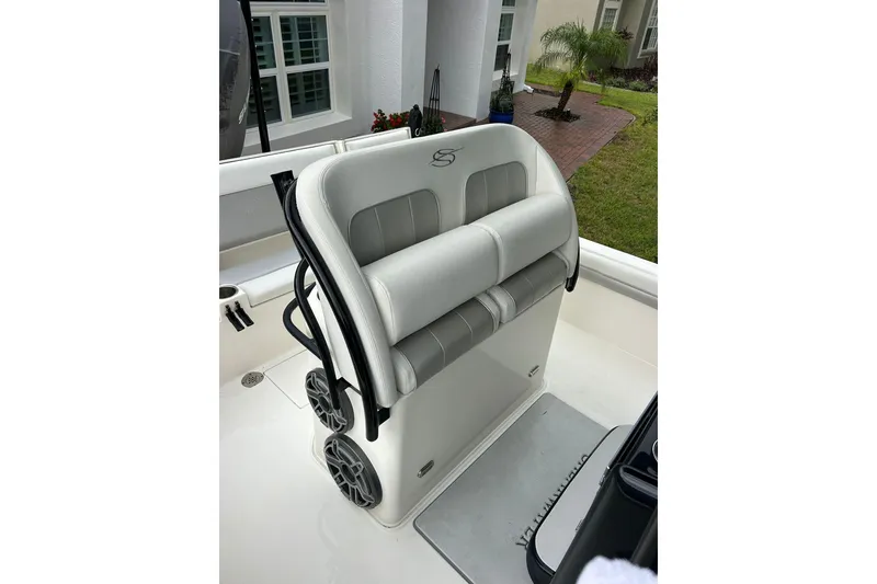 Slide: The Image of 2020 ShearWater 260 Carolina Flare boat interior with cushioned seating and speakers. - 29