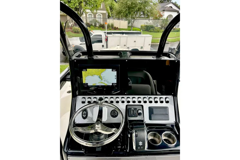 Slide: The Image of 2020 ShearWater 260 Carolina Flare boat dashboard with navigation screen and controls. - 31