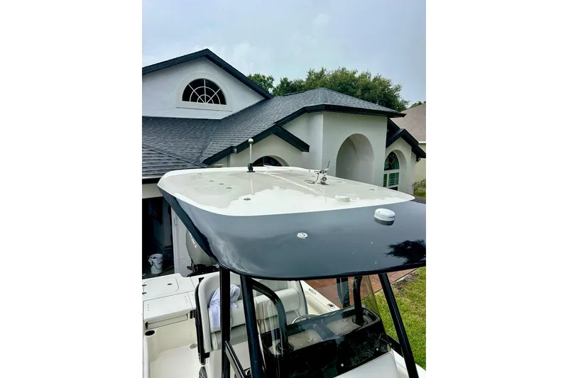 Slide: The Image of 2020 ShearWater 260 Carolina Flare boat with open storage compartments on calm water. - 8