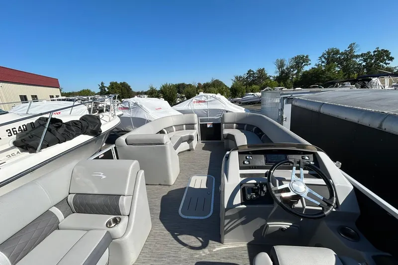 Slide: The Image of 2023 Bennington L 23 Swingback pontoon boat with spacious seating and modern helm. - 20