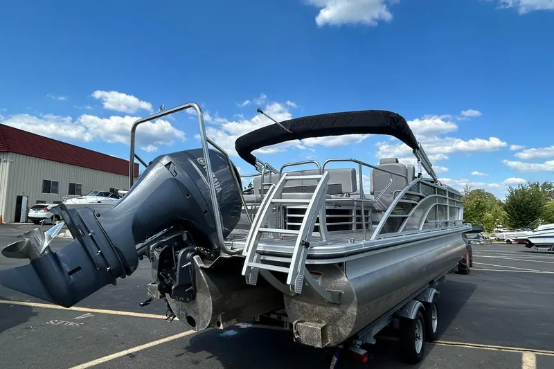 Slide: The Image of 2023 Bennington L 23 Swingback pontoon boat with Yamaha outboard motor, parked outdoors. - 6