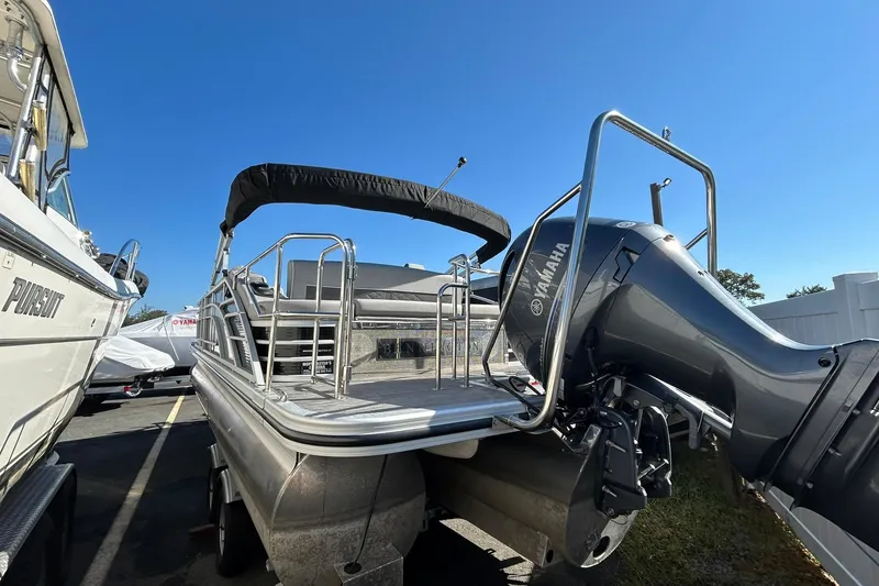 Slide: The Image of 2023 Bennington L 23 Swingback pontoon boat with Yamaha outboard motor, docked outdoors. - 8
