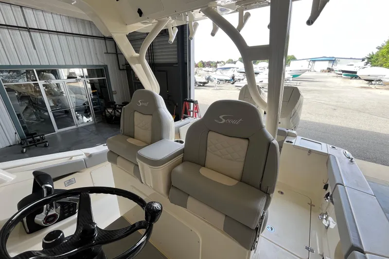 Slide: The Image of 2026 Scout 330 LXF boat interior with luxury seating and steering wheel. - 18