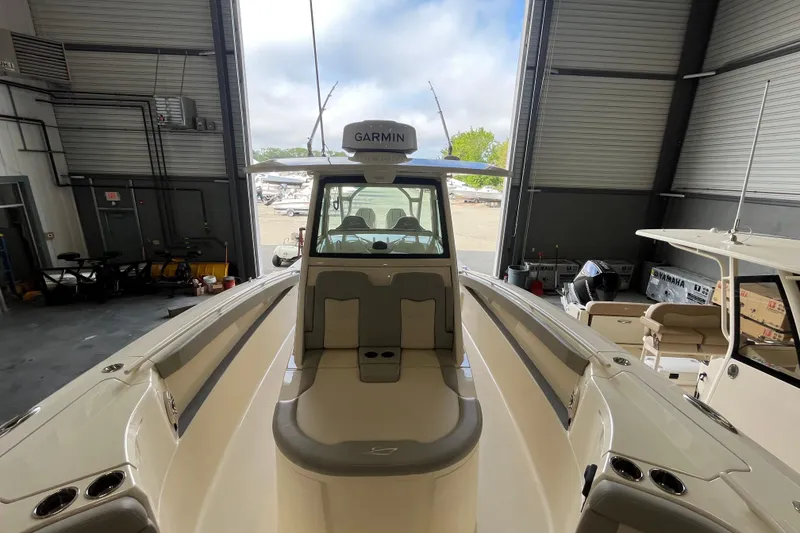Slide: The Image of 2026 Scout 330 LXF boat interior with Garmin equipment in a storage facility. - 19