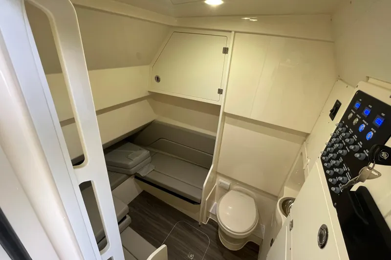 Slide: The Image of 2026 Scout 330 LXF cabin interior with seating, toilet, and control panel. - 22