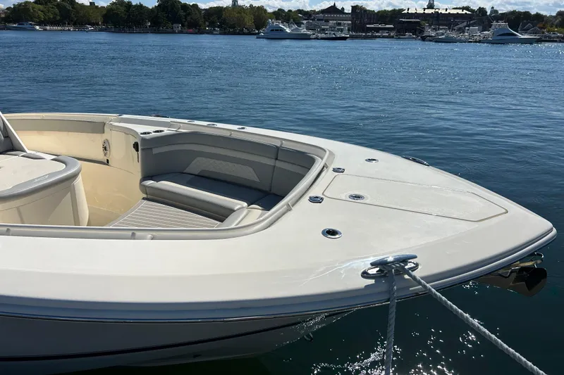 Slide: The Image of 2026 Scout 330 LXF boat docked on calm water, featuring spacious seating area. - 8