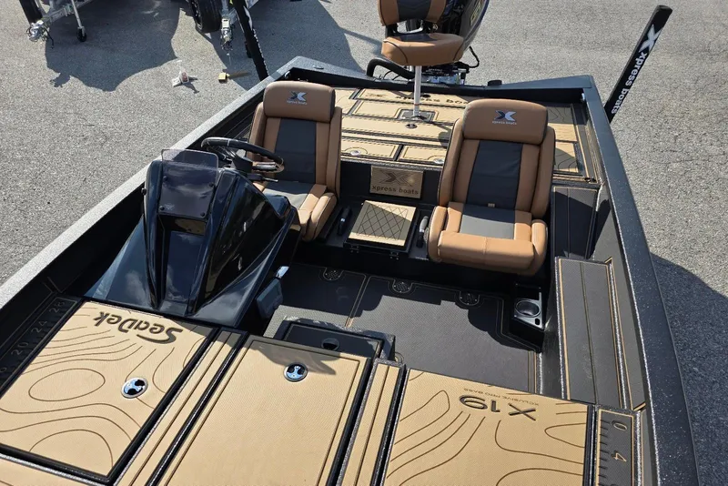 Slide: The Image of 2026 Xpress X19 Pro boat interior with tan and black seating and console. - 7