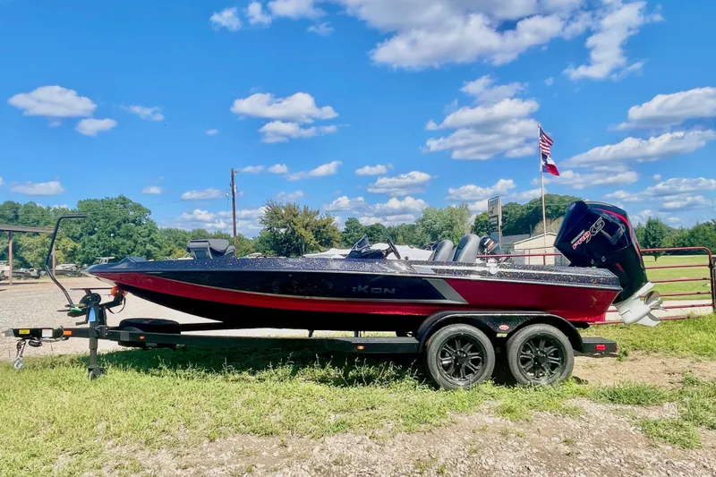 The Image of 2026 iKon VLE20 boat on trailer, parked outdoors under a clear blue sky. - 0