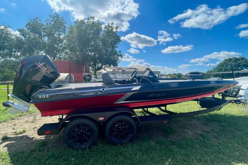 Slide: The Image of 2026 iKon VLE20 boat on trailer, parked on grass under a blue sky. - 1