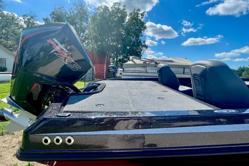 Slide: The Image of 2026 iKon VLE20 boat with Mercury Pro XS engine under a clear blue sky. - 2