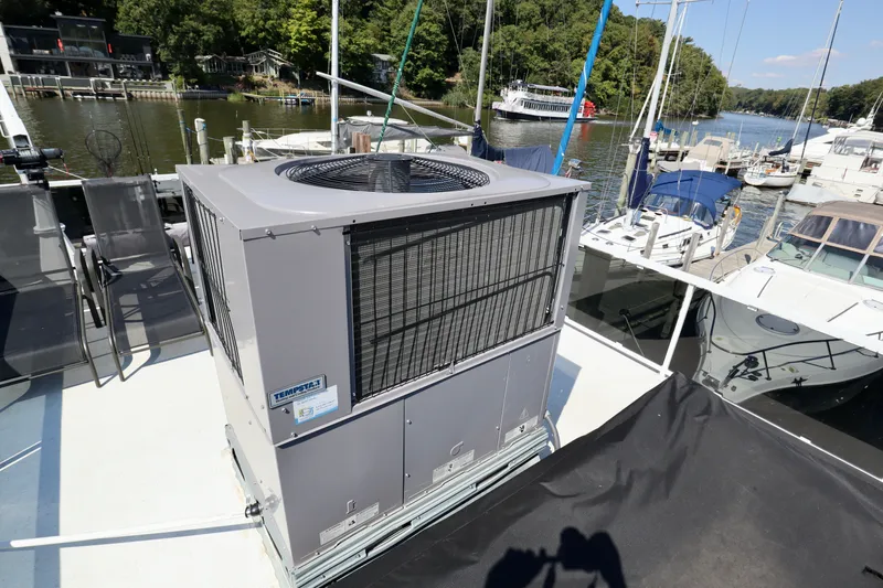 Slide: The Image of Rooftop air conditioning unit on a 1997 Fun Country Forerunner houseboat at a marina. - 12