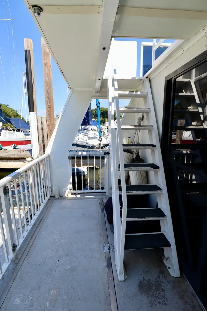 Slide: The Image of Staircase on 1997 Fun Country Forerunner houseboat docked at marina. - 14