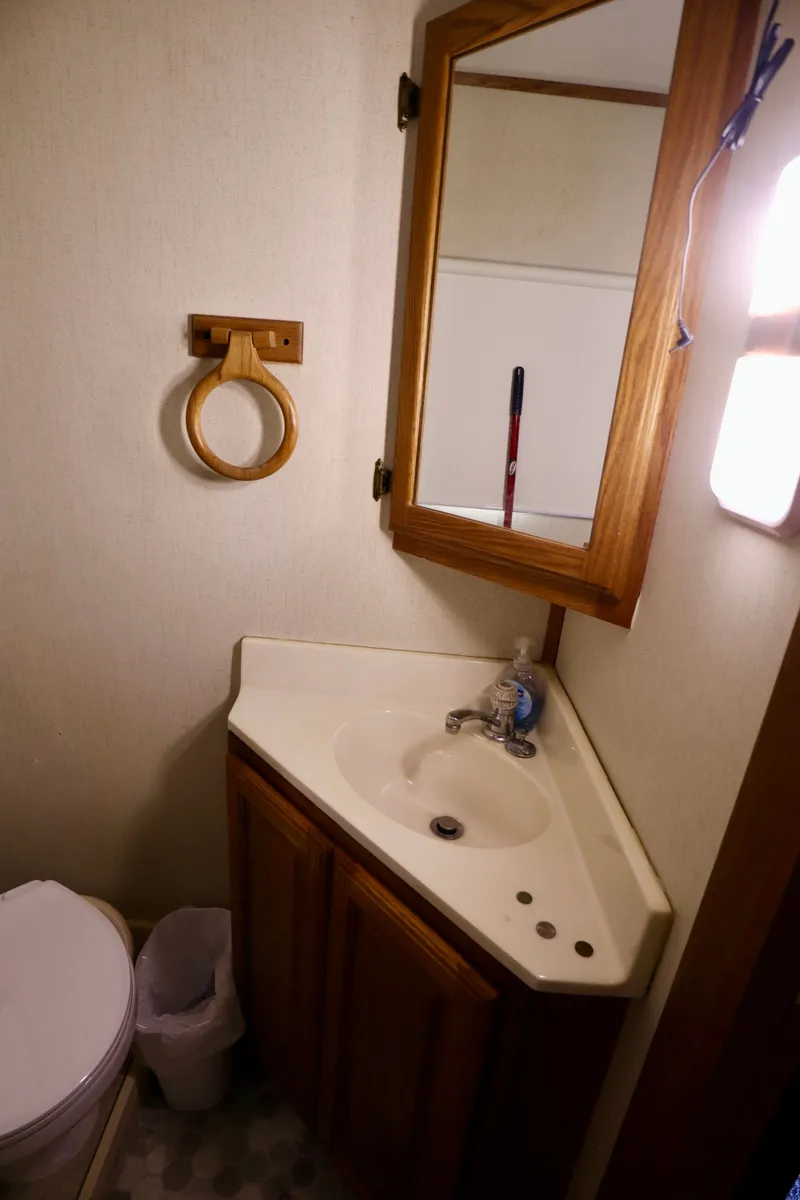 Slide: The Image of Compact 1997 Fun Country Forerunner bathroom with sink, mirror, and toilet. - 18