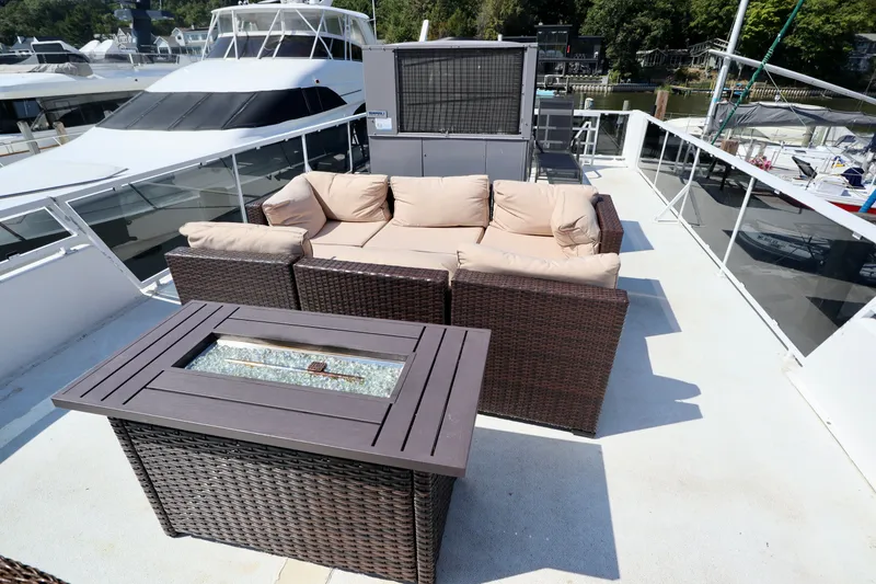 Slide: The Image of Outdoor seating area on 1997 Fun Country Forerunner yacht deck with wicker furniture and fire pit. - 2