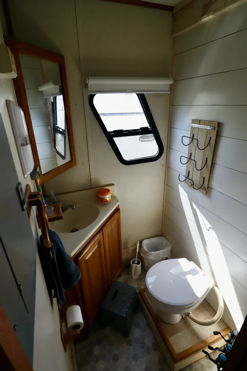 Slide: The Image of Compact bathroom in 1997 Fun Country Forerunner RV with sink, toilet, and window. - 21