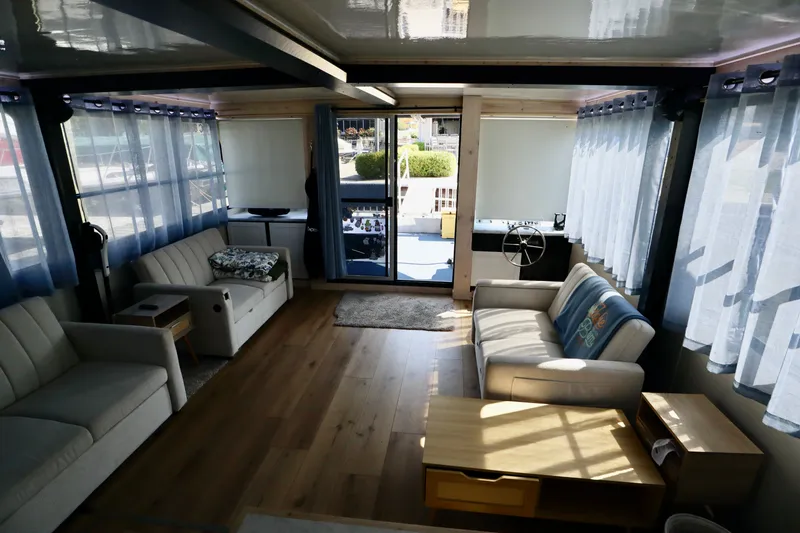 Slide: The Image of Interior of 1997 Fun Country Forerunner houseboat with sofas, wooden floor, and large windows. - 26