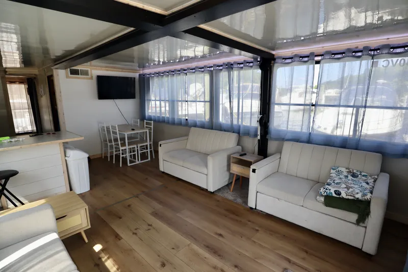 Slide: The Image of Spacious 1997 Fun Country Forerunner houseboat interior with modern furnishings and large windows. - 27
