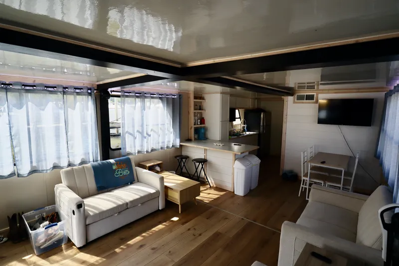 Slide: The Image of Interior of a 1997 Fun Country Forerunner houseboat with modern furnishings and natural light. - 30