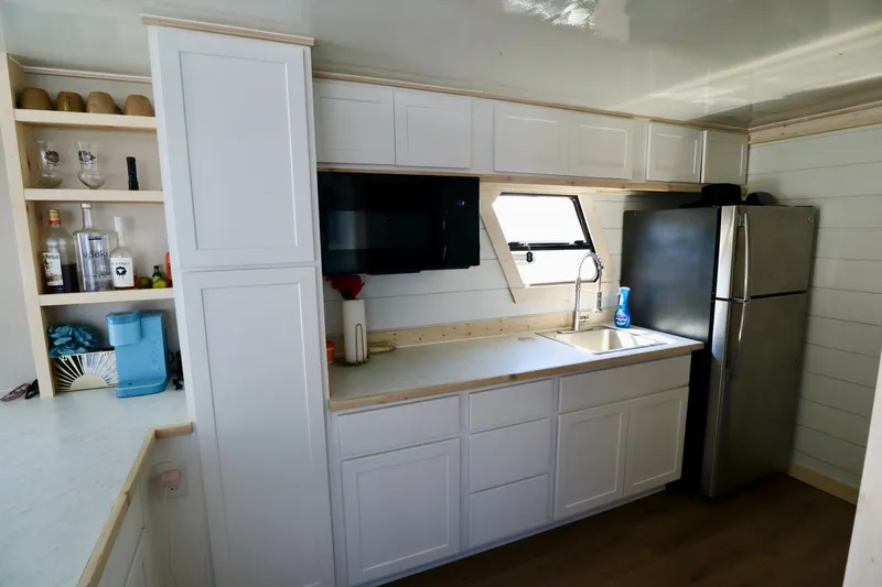 Slide: The Image of Modern kitchen in 1997 Fun Country Forerunner with white cabinets and stainless steel appliances. - 34