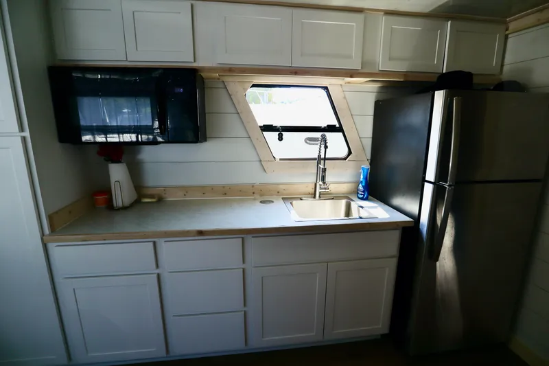 Slide: The Image of Compact kitchen in 1997 Fun Country Forerunner with stainless steel appliances and modern cabinetry. - 35