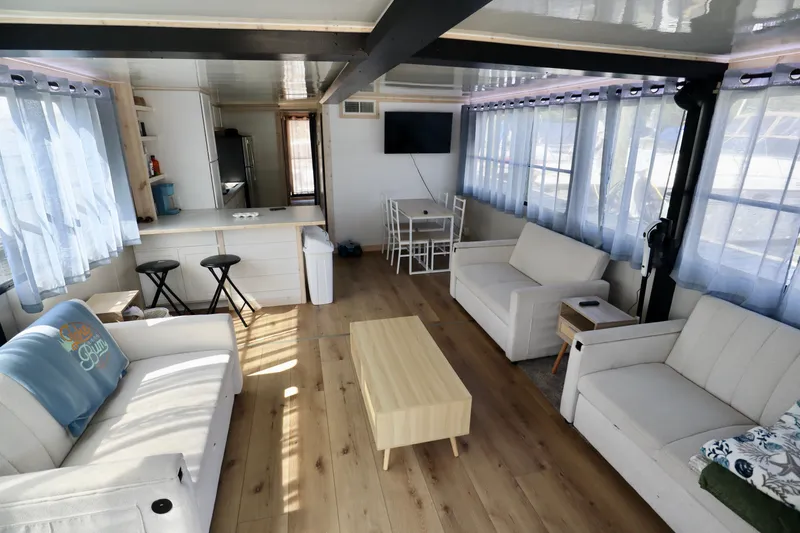 Slide: The Image of Spacious 1997 Fun Country Forerunner houseboat interior with modern furnishings and natural light. - 4