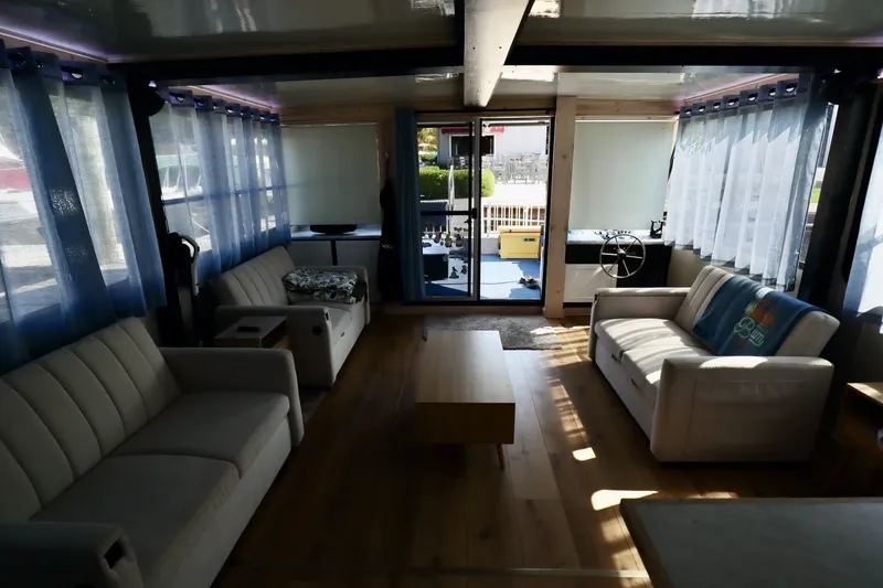 Slide: The Image of Interior of 1997 Fun Country Forerunner houseboat with sofas, wooden floor, and large windows. - 40