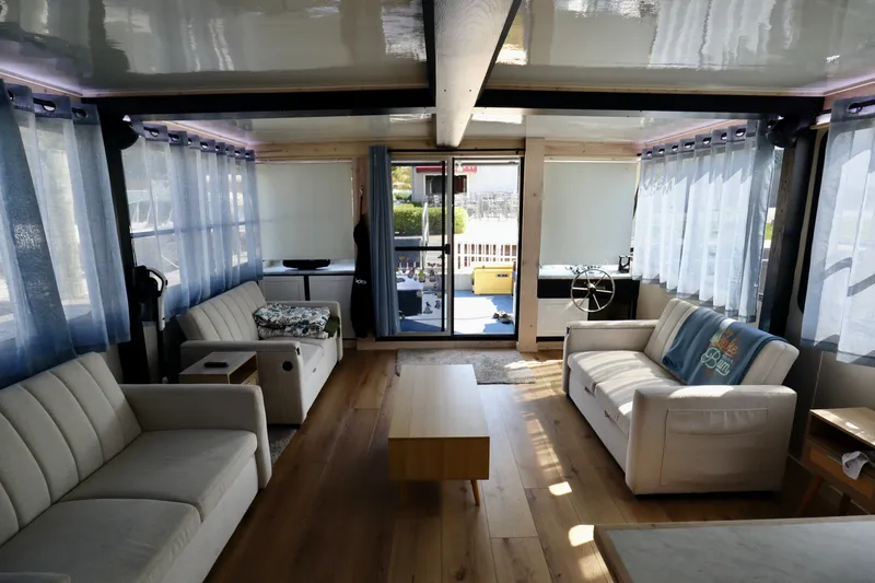 Slide: The Image of Spacious interior of a 1997 Fun Country Forerunner houseboat with modern furnishings and large windows. - 41