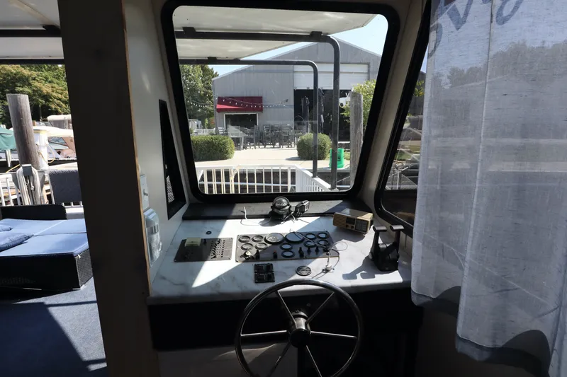 Slide: The Image of Interior view of a 1997 Fun Country Forerunner boat cockpit with steering wheel and control panel. - 42