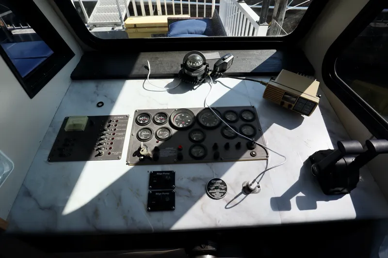 Slide: The Image of Control panel of a 1997 Fun Country Forerunner boat with gauges and switches. - 43