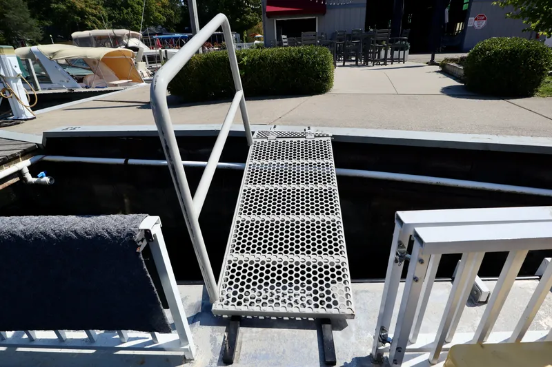 Slide: The Image of Metal dock ramp on a 1997 Fun Country Forerunner boat, leading to a marina. - 45
