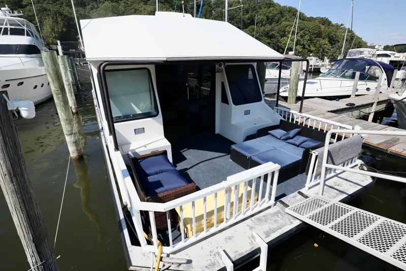 Slide: The Image of Houseboat docked at marina, featuring outdoor seating, Fun Country Forerunner, 1997 model. - 46