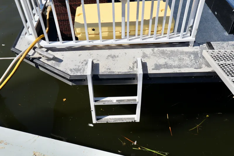 Slide: The Image of Boat deck with ladder, railing, and yellow storage box, Fun Country Forerunner 1997. - 48