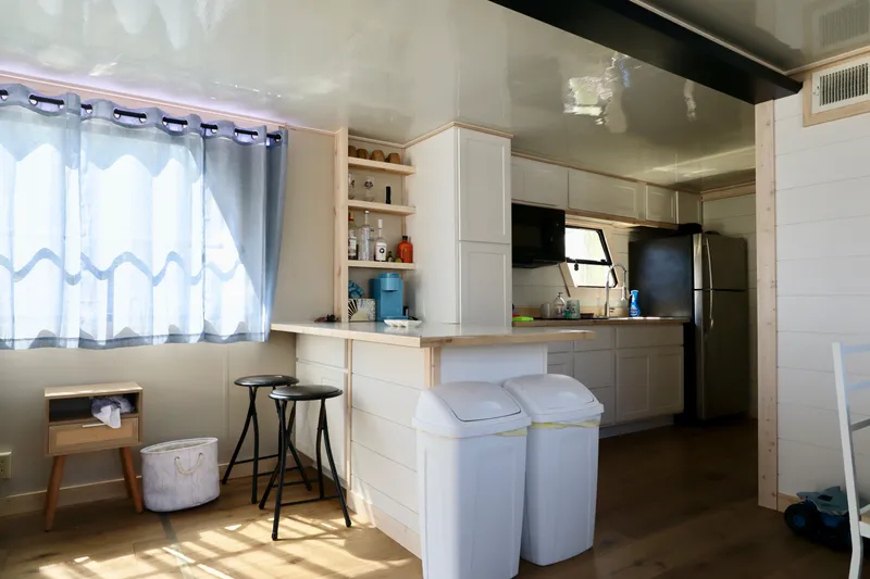 Slide: The Image of Modern kitchen interior in a 1997 Fun Country Forerunner houseboat, featuring sleek cabinets and bar stools. - 5