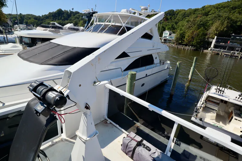 Slide: The Image of Luxury yacht docked at marina, surrounded by lush greenery, featuring a 1997 Fun Country Forerunner. - 9