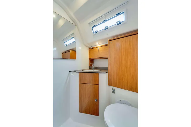 Slide: The Image of Modern bathroom in 2016 Bavaria 51 Cruiser yacht with wooden cabinetry and sleek fixtures. - 12