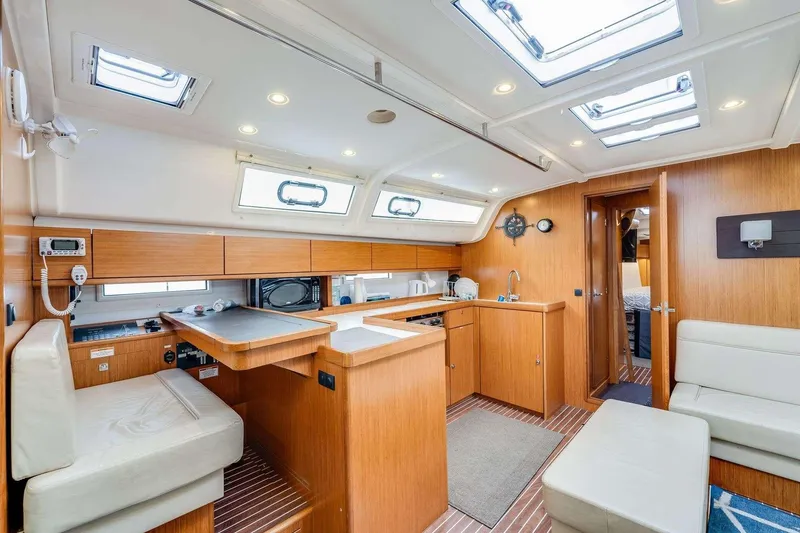 Slide: The Image of Interior of 2016 Bavaria 51 Cruiser yacht with modern kitchen and seating area. - 15