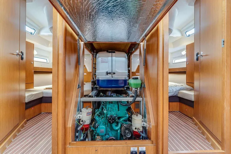 Slide: The Image of Engine room of 2016 Bavaria 51 Cruiser yacht with visible engine and wooden interior. - 19