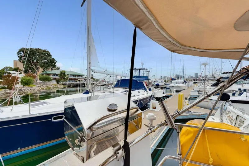 Slide: The Image of 2016 Bavaria 51 Cruiser yacht docked in a marina, surrounded by other boats. - 26