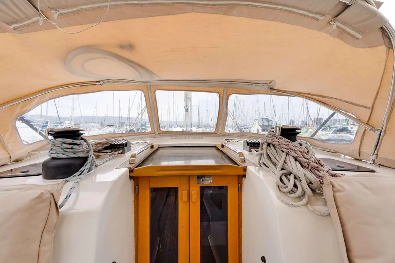 Slide: The Image of 2016 Bavaria 51 Cruiser yacht cockpit with ropes and covered seating in marina. - 27