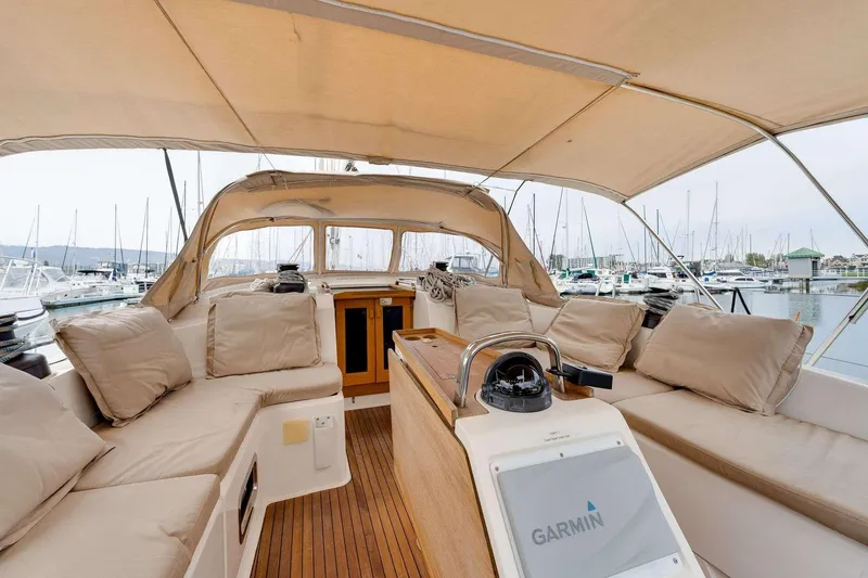 Slide: The Image of Spacious cockpit of 2016 Bavaria 51 Cruiser yacht with beige cushions and Garmin navigation. - 29