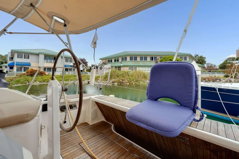 Slide: The Image of 2016 Bavaria 51 Cruiser yacht cockpit with blue cushioned seat and steering wheel. - 30
