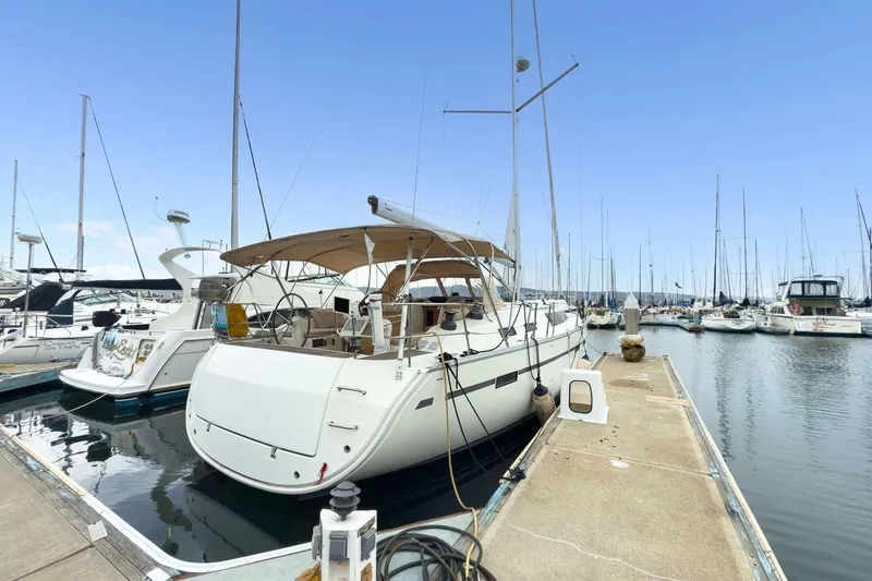Slide: The Image of 2016 Bavaria 51 Cruiser yacht docked at marina, clear sky, calm waters. - 31