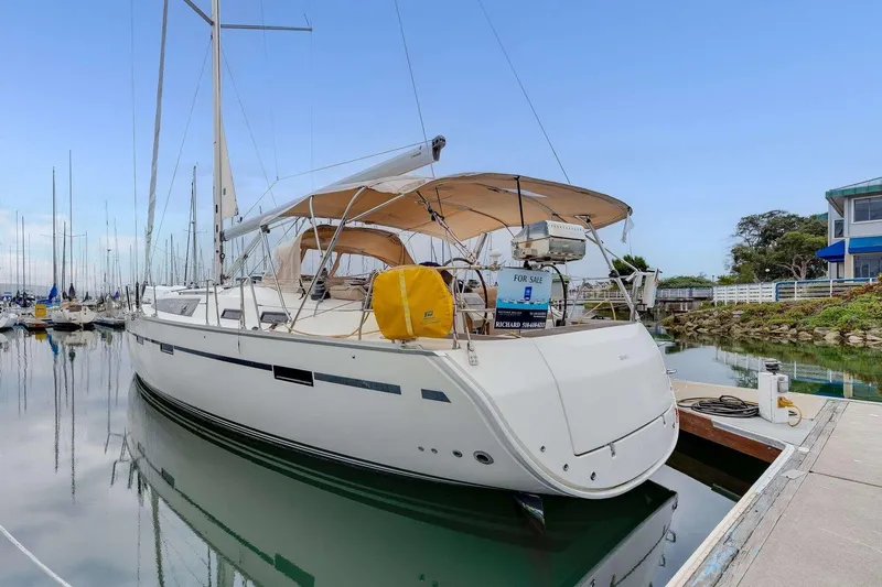 Slide: The Image of 2016 Bavaria 51 Cruiser yacht docked at marina, featuring sleek design and beige canopy. - 32