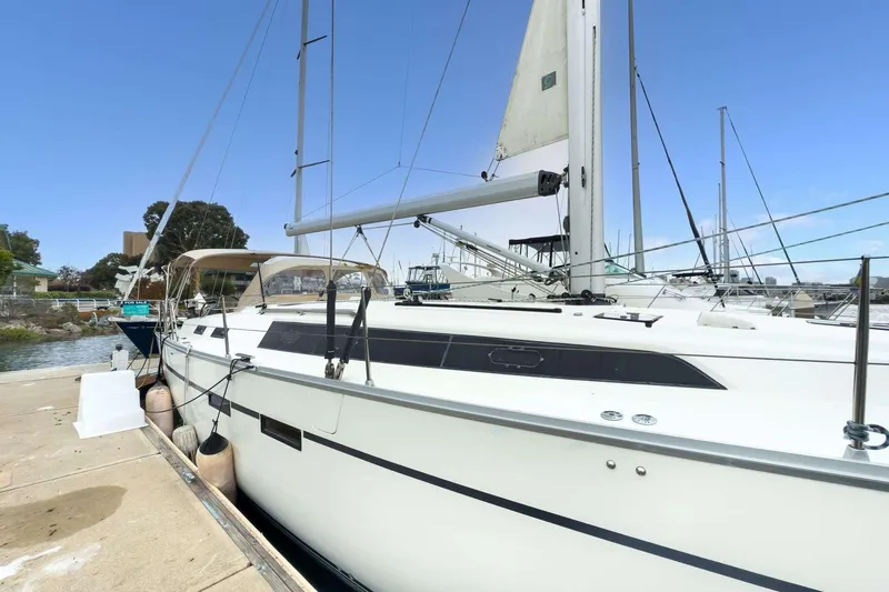 Slide: The Image of 2016 Bavaria 51 Cruiser yacht docked at marina under clear blue sky. - 33