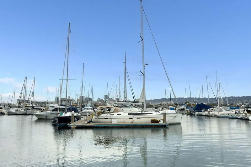 Slide: The Image of Sailboats docked in a marina, featuring a 2016 Bavaria 51 Cruiser under a clear blue sky. - 34