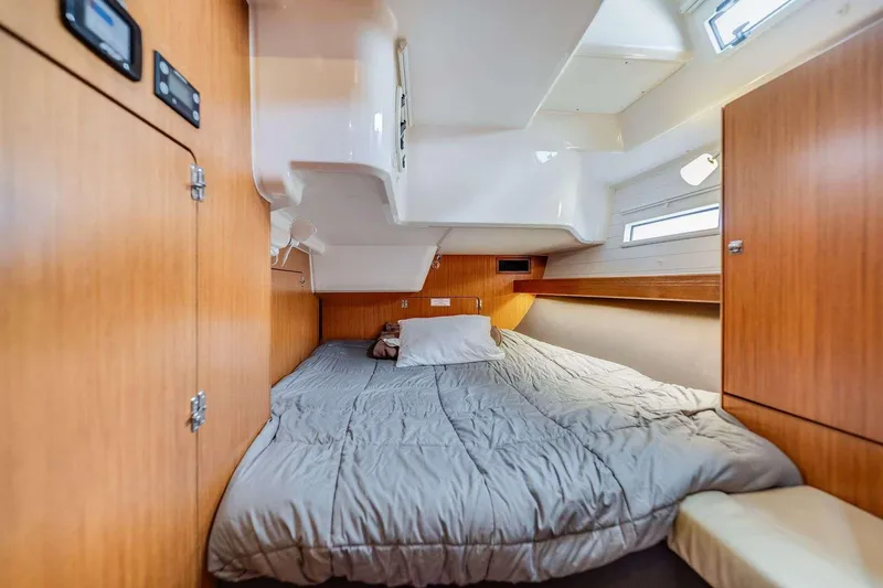 Slide: The Image of Cozy cabin interior of 2016 Bavaria 51 Cruiser yacht with wooden finish and comfortable bedding. - 7