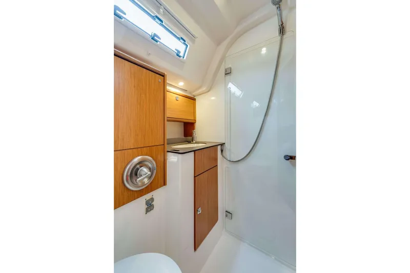 Slide: The Image of 2016 Bavaria 51 Cruiser bathroom with wooden cabinets and modern shower. - 8