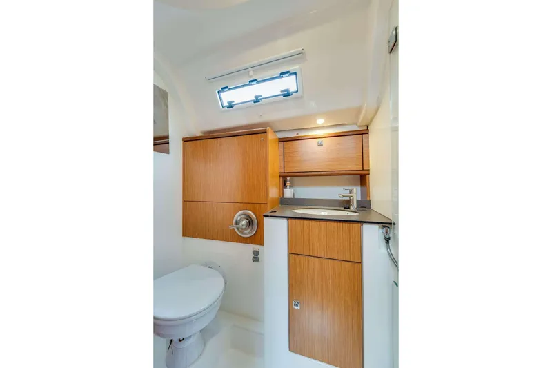 Slide: The Image of Modern bathroom interior of 2016 Bavaria 51 Cruiser yacht with wooden cabinetry and sleek fixtures. - 9