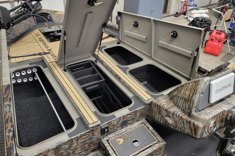 Slide: The Image of Interior of 2026 Xpress X19 Pro boat with storage compartments and Garmin equipment. - 4