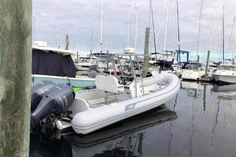 Slide: The Image of 2014 AB Inflatables Oceanus 28 VST boat docked in a marina with other vessels. - 11